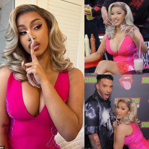 Cardi B the blonde bombshell almost spills out of her VERY low-cut pink mini dress while filming new interview